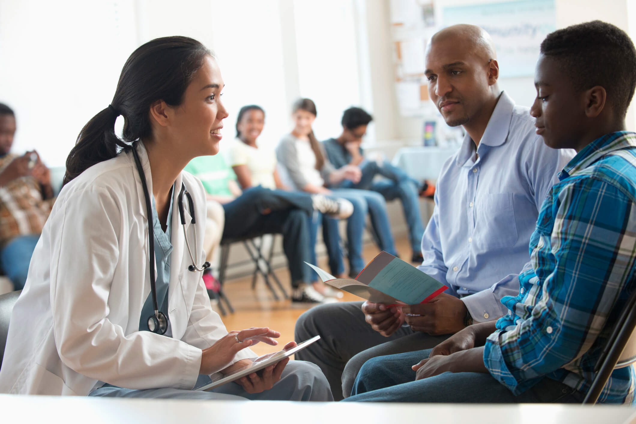 Female medical professional speaking with a patient.