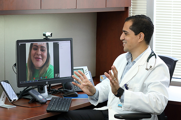 Erik Rivera talking with patient