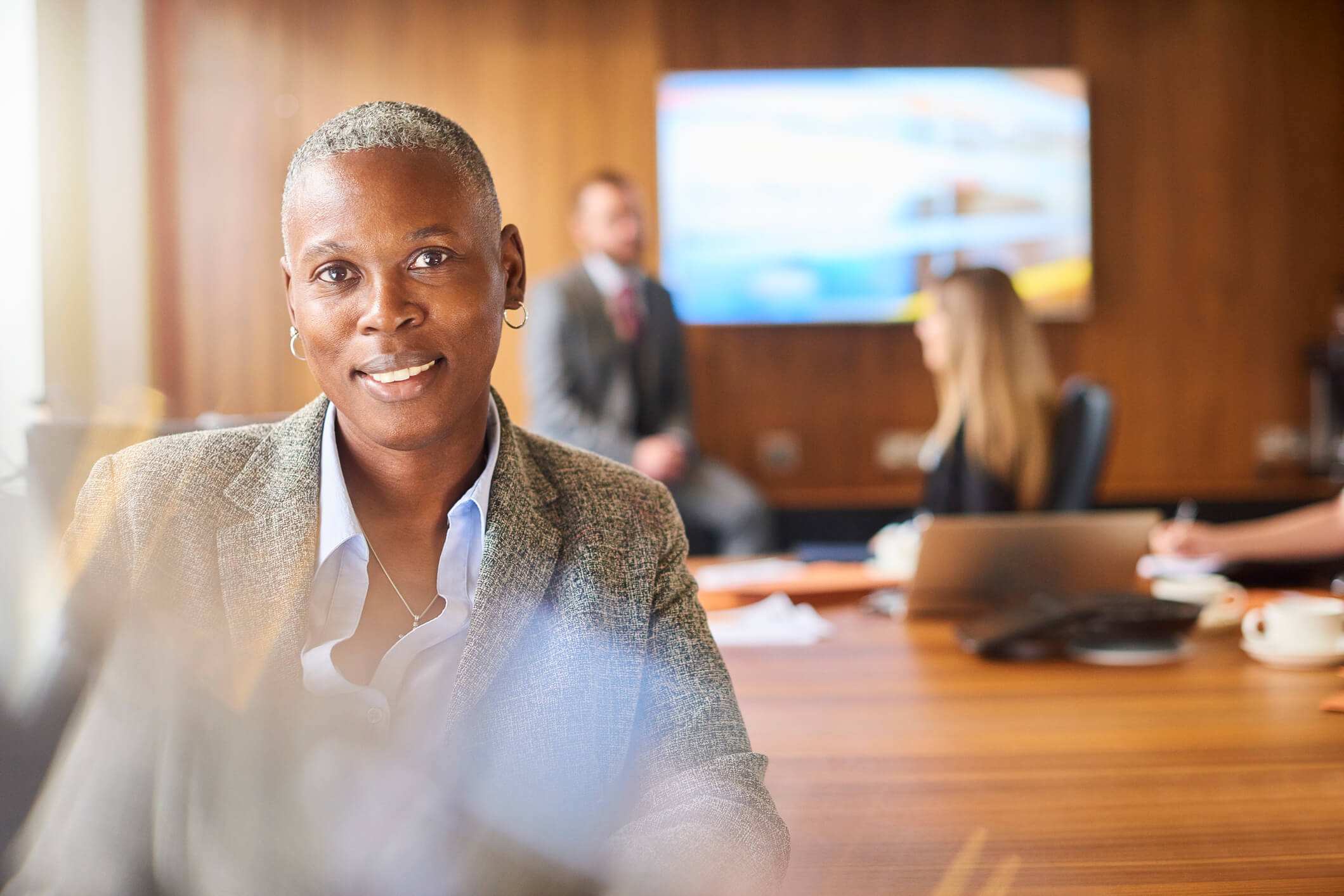 Woman smiling at the camera in an office setting.