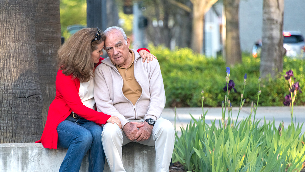 senior man possing with his daughter